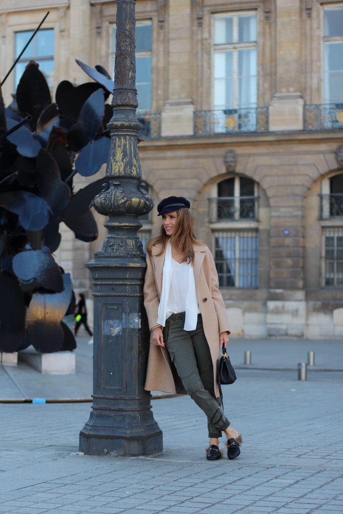 Place Vendôme, PARIS, FRANCE - NOVEMBER : German model and fashion blogger Alexandra Lapp (@alexandralapp_) wearing a camel coat, tie neck blouse and pants by Marc Aurel, princetown slippers from Gucci and peekaboo mini bag from Fendi, on November 2016 in Paris, France. *** Local Caption *** Alexandra Lapp
