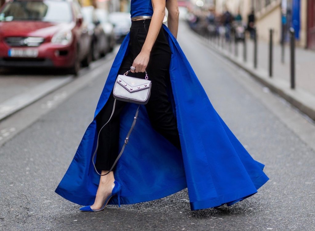 PARIS; FRANCE; Model and Blogger Alexandra Lapp wearing asymmetric one shoulder silhouette, blue taffeta and leather top from Pearl and Rubies with a skin barring asymmetric one-shoulder Silhouette, Black pants from Pearl and Rubies, Blue suede plexi pumps from Gianvito Rossi, Catherine shoulder mini bag in silver from MCM on March 4, 2017 in Paris, France.