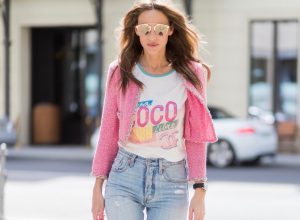 Alexandra Lapp (model, blogger) wearing Stark mini backpack in pink from MCM, Visetos-print coated canvas, a high waist, non-strech denim and five-pocket 501 skinny jeans from Levi's, a graphic Chanel T-Shirt printed with Viva Coco Cuba Libre from Chanel Cuba Cruise 2017 collection, a short vintage tweed jacket in pink from Chanel, Christian Louboutin So Kate pumps in neon yellow and 'Dior Reflected Aviator' sunglasses in gold from Dior during the Mercedes-Benz Fashion Week Berlin Spring/Summer 2018 on July 6, 2017 in Berlin, Germany.