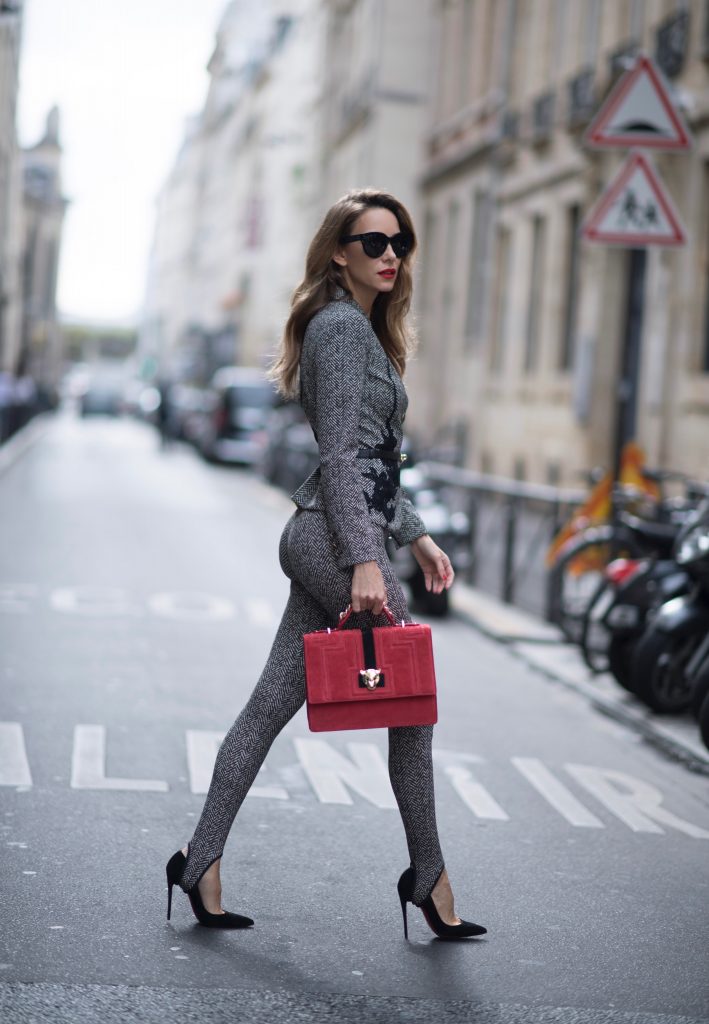Alexandra Lapp seen wearing stirrup pants and blazer in checkered pattern, glencheck and a red bag by Marc Cain, So Kate pumps from Christian Louboutin, Celine Audrey sunglasses and a waist belt by Hermes in the streets of Paris on September 27, 2017 in Paris, France.