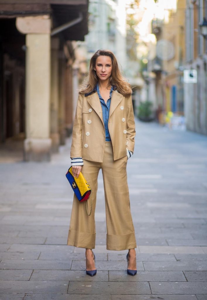 BARCELONA, SPAIN - NOVEMBER 27: Alexandra Lapp wearing wide cut khaki pants from Steffen Schraut, khaki jacket with blue collar and blue and white strips on the bottom of the sleeve from Steffen Schraut, denim shirt by Steffen Schraut, So Kate Pumps from Christian Louboutin in denim, Chanel 2.55 bag in red, blue and yellow with golden logo buckle on November 27, 2017 in Barcelona, Spain.
