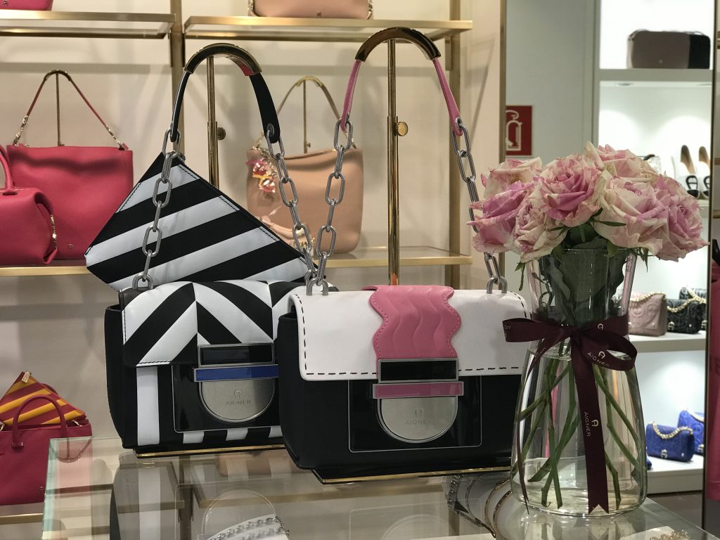 #AIGNERLOVE - DUESSELDORF Aigner shop, May 2018, Model and Blogger Alexandra Lapp wearing the it-bag Aigner Candice bag S in pink with black and white combined with the Love shoulder strap.