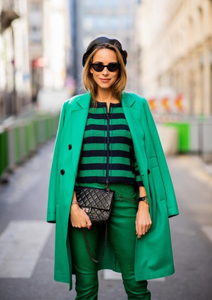 Alexandra Lapp in a Go Green Look wearing green skinny Riani leather pants, black green striped knit with a zipper by Riani, a green oversized blazer jacket by Riani, a black Chanel 2.55 flap bag, black suede Christian Louboutin high heels, cat-eye shaped Isabella Sunglasses by illesteva and a black Eugenia Kim beret during Paris Fashion Week Womenswear Spring/Summer 2019 on September 27, 2018 in Paris, France.