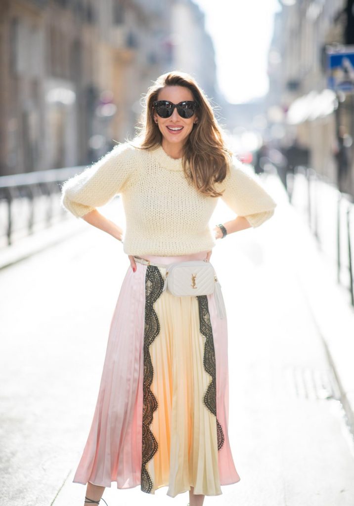Alexandra Lapp in a Fashion Double look, wearing a chunky knit sweater from Ganni, a multi colored Self-Portrait plissée-skirt, Saint Laurent Blanc Vi belt bag, black Gianvito Rossi sandals and Céline Audrey sunglasses and Isabel Lapp is seen wearing a Sandro suit with double breasted blazer in light pink and matching high waisted pants, Saint Laurent mini bag, Isabel Marant heels and Céline Shadow sunglasses, all by Breuninger, seen during Paris Fashion Week Womenswear Fall/Winter 2019/2020 on February 27, 2019 in Paris, France. (Photo by Christian Vierig/Getty Images)