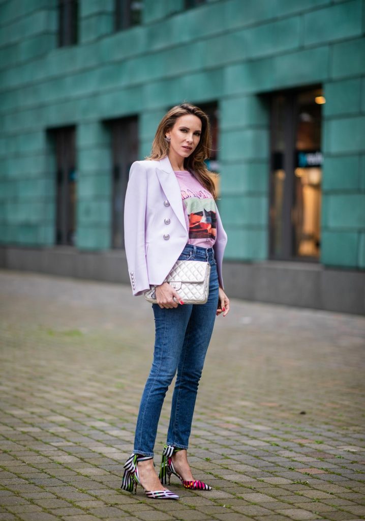 Alexandra Lapp in a Balenciaga Blazer look, wearing a pastel lilac double breasted blazer from Balenciaga, a pastel t-shirt with a logo print from Balmain, high rise skinny jeans Olivia from Citizens of Humanity, a vintage silver flap bag by Chanel and the Toubinana 80 Satin Cinestripes Multicolored Pumps from Christian Louboutin on May 01, 2019 in Duesseldorf, Germany. (Photo by Christian Vierig/Getty Images)
